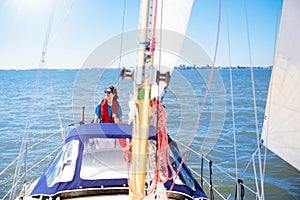 Young man sailing. Teenager boy on sea sail boat.