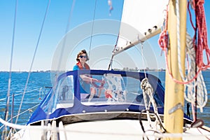 Young man sailing. Teenager boy on sea sail boat.