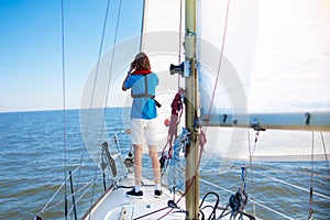 Young man sailing. Teenager boy on sea sail boat.