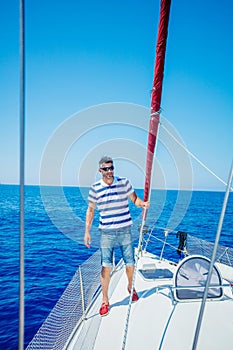 Young man sailing yacht. Holidays, people, travel