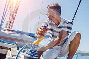 Young man sailing yacht. Holidays, people, travel