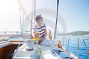 Young man sailing yacht. Holidays, people, travel