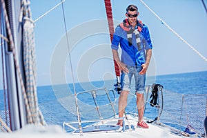 Young man sailing yacht. Holidays, people, travel