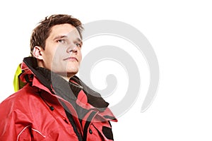 Young man sailor in red wind jacket. Sailing.