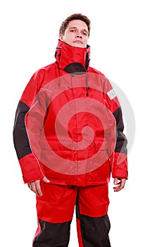 Young man sailor in red wind jacket. Sailing.