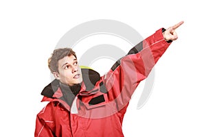 Young man sailor in red wind jacket. Sailing.