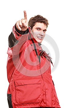 Young man sailor in red wind jacket. Sailing.