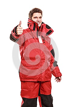 Young man sailor in red wind jacket. Sailing.