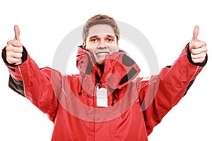 Young man sailor in red wind jacket. Sailing.