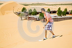Young man sand boarding