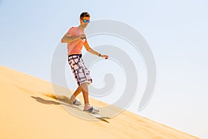Young man sand boarding