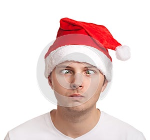 Young man in santa hat with crossed eyes