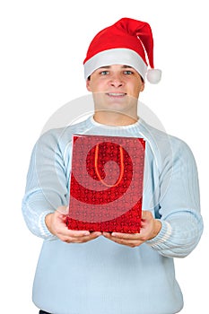 Young man in santa's hat holding present bag