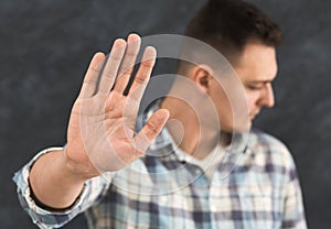 Young man saying stop, denial gesture