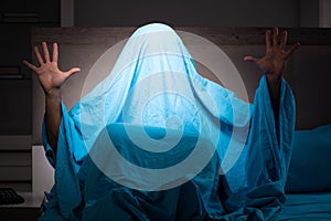 The young man scared in his bed having nightmares