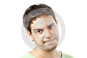 Young man sceptically looking isolated on white