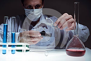 Young man scientist using auto-pipette with flask in medical science laboratory. Researcher concept.