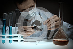 Young man scientist using auto-pipette with flask in medical science laboratory. Researcher concept.