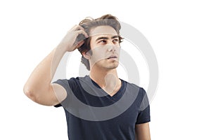Young man scratching his head