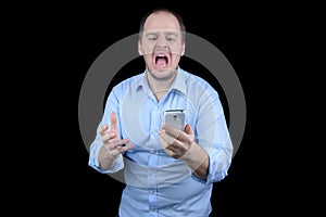 Young man screaming at mobile phone