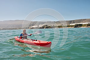 Young man in sea kayak