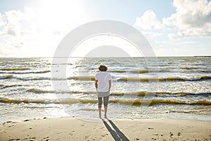 Young man at sea summer beach