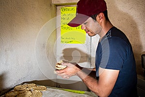 Young man selling tortillas of nixtamal
