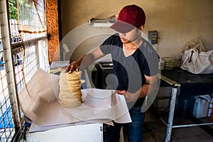 Young man selling tortillas of nixtamal