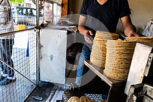 Young man selling tortillas of nixtamal