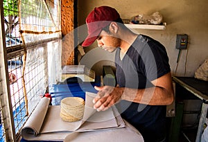 Young man selling tortillas of nixtamal