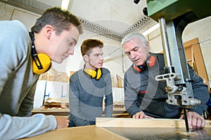 Young man and senior on woodwork apprenticeship