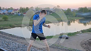 Young man,shadow boxing on outdor,sunset