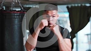 Young man shadow boxing to a camera