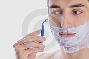 Young man shaving