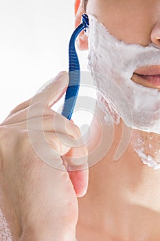 Young man shaving