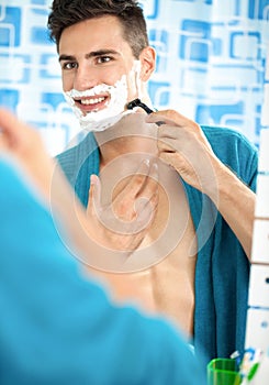 Young man shaving