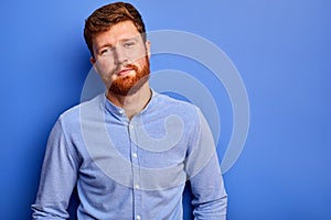 Young man in shirt posing at camera isolated