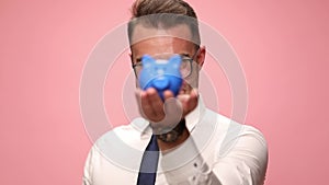 young man in shirt and tie on pink background