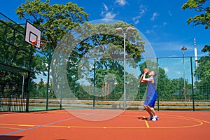 Young man shoots basketball ball