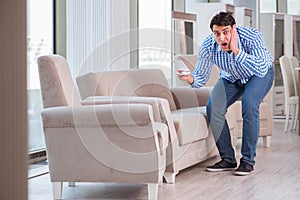 The young man shopping in furniture store