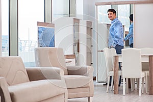 The young man shopping in furniture store