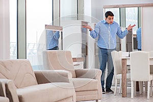 The young man shopping in furniture store