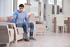 The young man shopping in furniture store