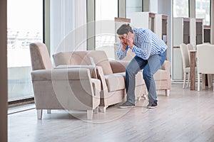 The young man shopping in furniture store