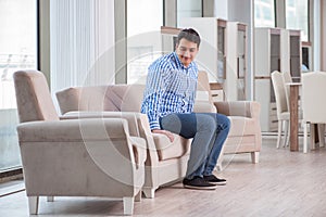 The young man shopping in furniture store