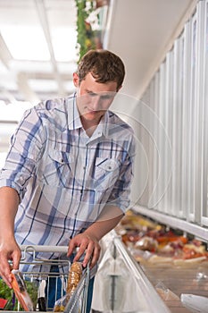 Young man shopping for pre-pack in a grocery store