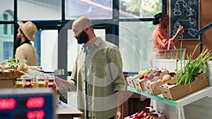 Young man shops at local supermarket