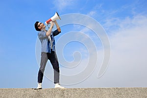 Young man shout megaphone