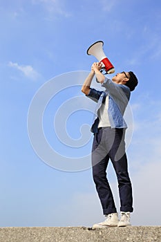 Young man shout megaphone photo