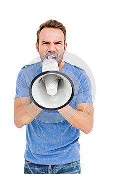 Young man shouting on horn loudspeaker